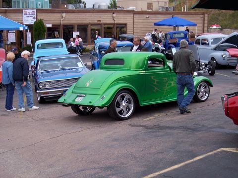 1972 Ford Ranchero - A custom green coupe with flame decals is parked at an outdoor event.