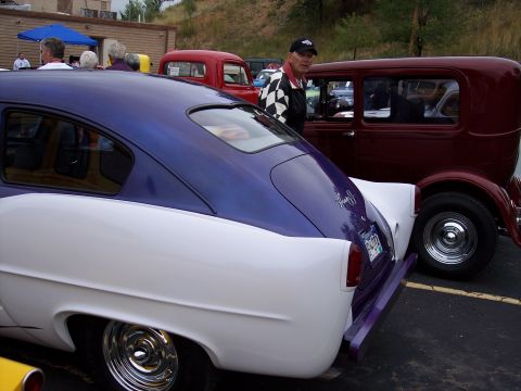 1972 Ford Ranchero - Two custom cars are parked side-by-side at an outdoor event.