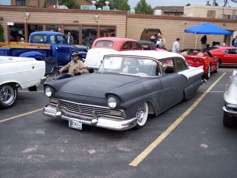 1972 Ford Ranchero - A 1957 Ford Fairlane 500 is parked in a lot with other vehicles visible.
