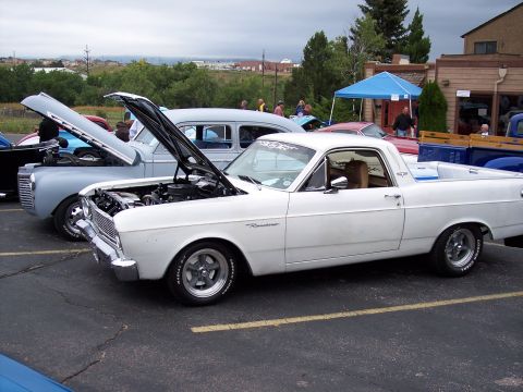 1972 Ford Ranchero - A white 1968 Ford Ranchero is displayed with its hood open at an outdoor car show.
