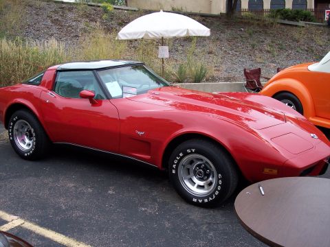 1972 Ford Ranchero - Red 1975 Chevrolet Corvette with black T-top and chrome wheels parked next to an orange car.