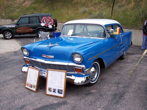 1972 Ford Ranchero - A blue and white 1956 Chevrolet sedan is displayed with informational boards in front of it.