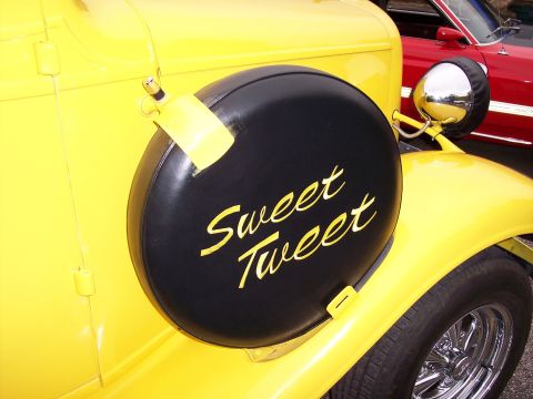 1972 Ford Ranchero - Spare tire cover on a yellow vintage car reads 'Sweet Tweet'.
