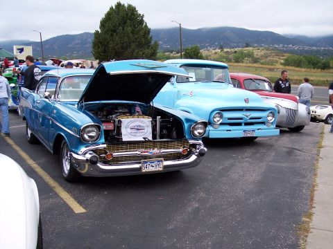 1972 Ford Ranchero - A blue 1957 Chevrolet Bel Air is displayed with its hood open, parked alongside other classic vehicles.