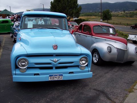 1972 Ford Ranchero - Two classic Ford vehicles, a pickup and a coupe, parked side-by-side at an outdoor event.