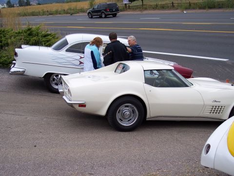 1972 Ford Ranchero - Two classic cars, a Corvette Stingray and a car with flames, are parked side-by-side.