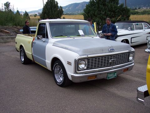 1972 Ford Ranchero - A partially restored pickup truck with a distinctive grille and a Colorado license plate is parked outdoors.
