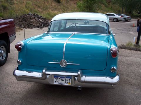 1972 Ford Ranchero - Rear view of a turquoise and white sedan with a chrome bumper and Colorado license plate.