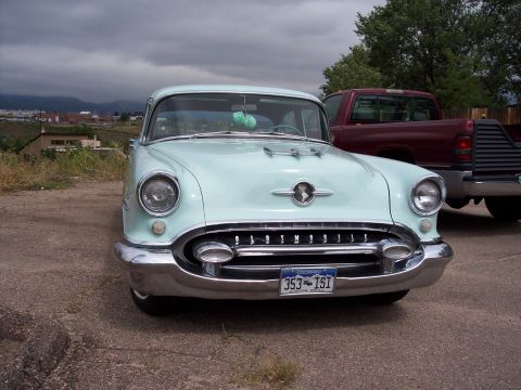 1972 Ford Ranchero - Pale blue 1954 Oldsmobile 88 with a distinctive grille and chrome bumper.