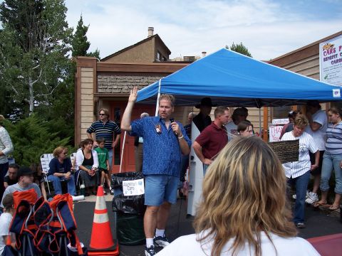 1972 Ford Ranchero - A man addresses a crowd at an outdoor event, possibly a fundraiser or community gathering.