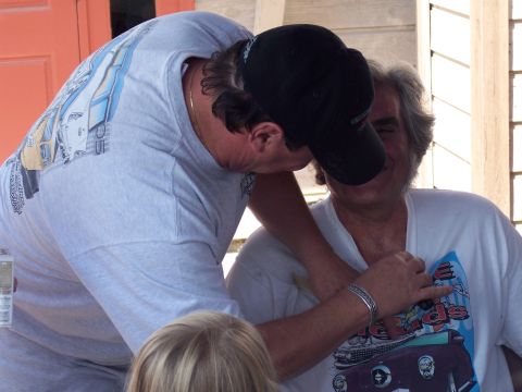 1972 Ford Ranchero - Two men interact while one wears a t-shirt displaying classic car artwork.