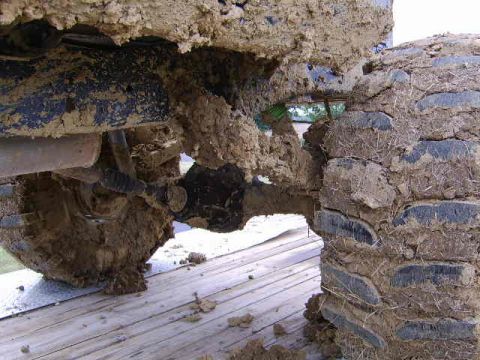 1986 Ford Ranger - This close-up shows the heavily mud-caked suspension and tire of a vehicle, likely after off-roading.