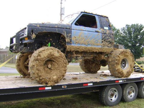1986 Ford Ranger - This heavily modified 1986 Ford Ranger is loaded onto a trailer, caked in mud from off-roading.