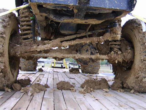1986 Ford Ranger - Undercarriage of a heavily mud-covered truck, likely after an off-road event.