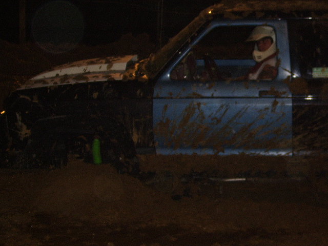 1986 Ford Ranger driving through mud, driver wearing helmet