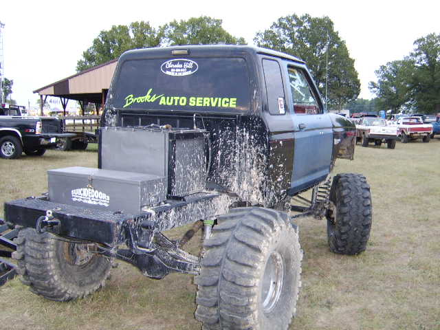 Rear view of a 1986 Ford Ranger mud bog truck with large tires and "Brooks Auto Service" decal