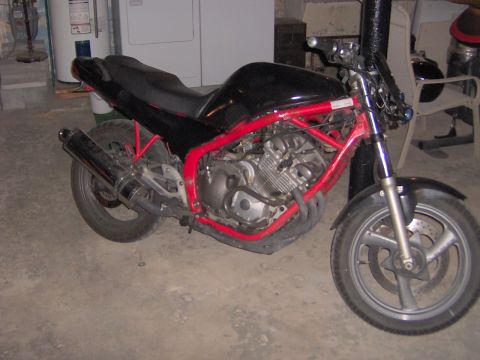 1993 Yamaha Seca II - A black motorcycle with a red frame is parked indoors.