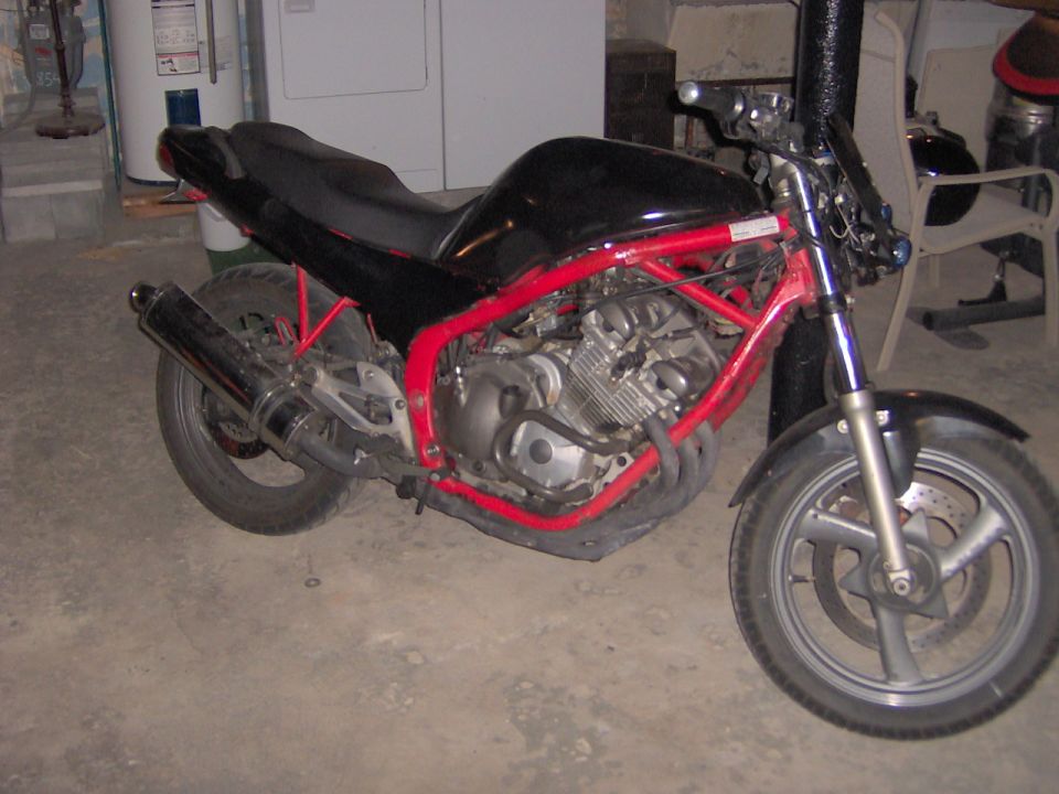 Black motorcycle with red frame, side view
