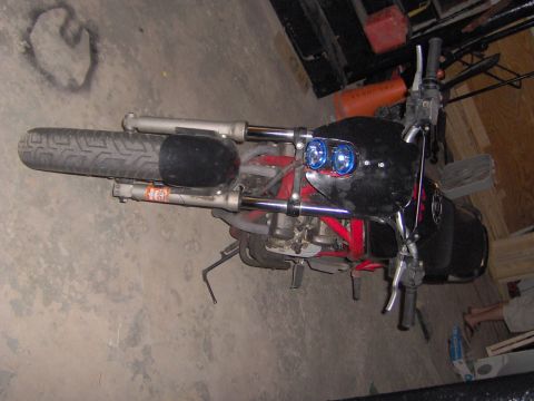 1993 Yamaha Seca II - Motorcycle front end with dual blue headlights and black fairing in a garage.