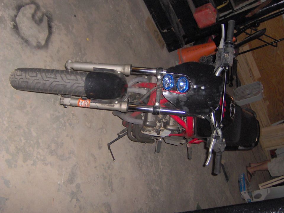 Motorcycle front end with dual blue headlights and black fairing