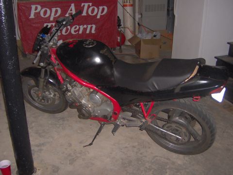 1993 Yamaha Seca II - A black motorcycle with a red frame is parked in what appears to be a garage or basement area.