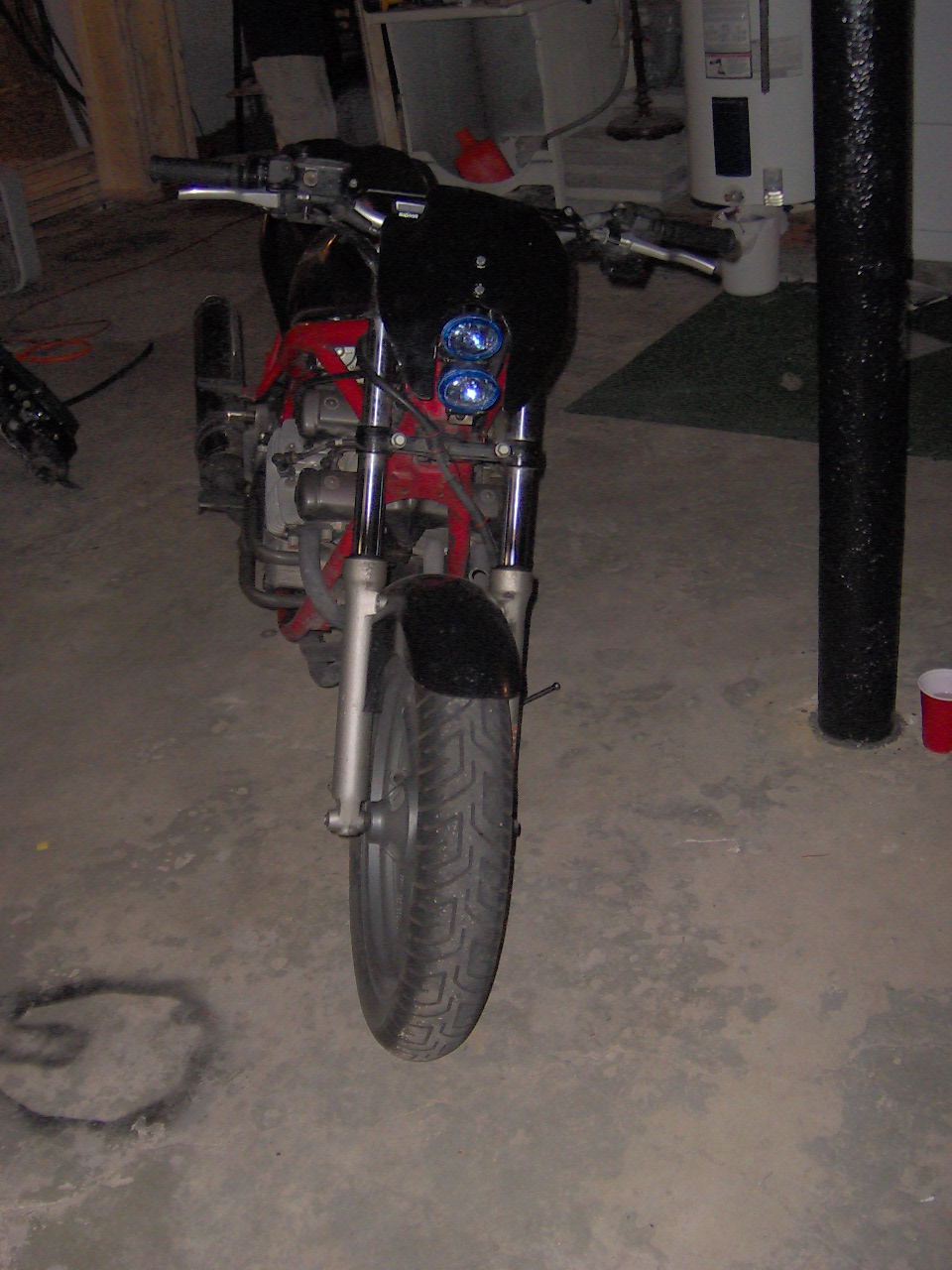 Front view of a motorcycle with a black fairing and dual headlights