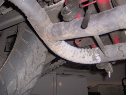 1993 Yamaha Seca II - A close-up view of a motorcycle's undercarriage, focusing on the exhaust system and drive chain.