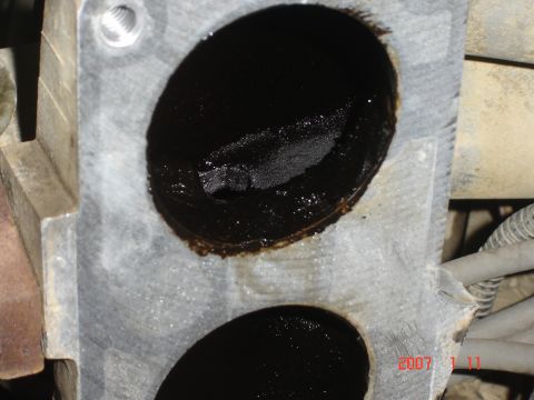 1993 Ford Bronco - Throttle body shows significant carbon deposits within its intake ports.