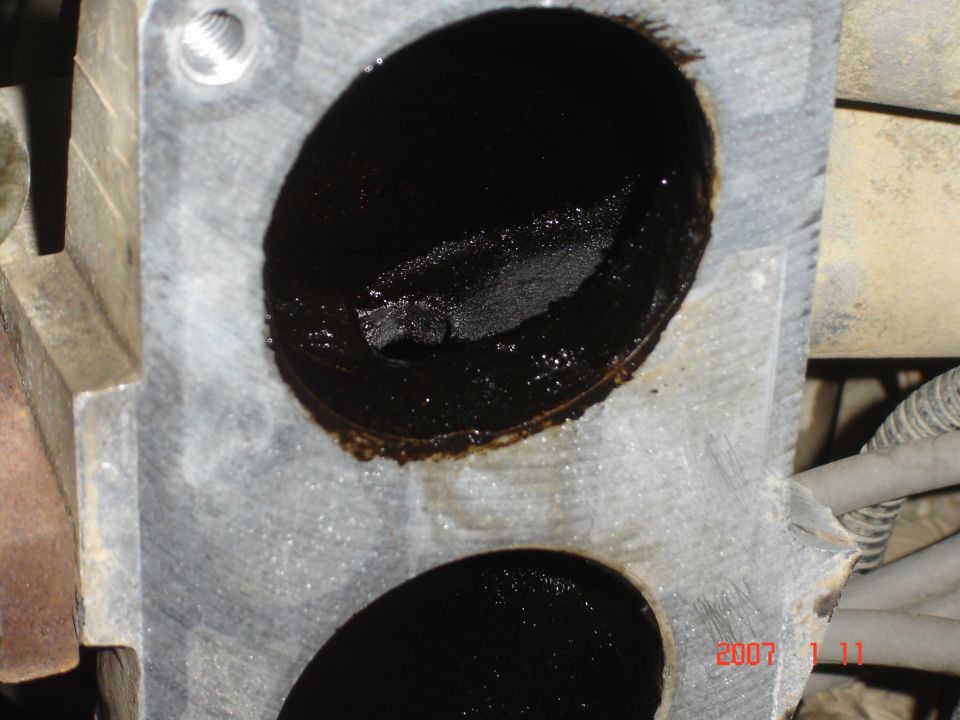 Throttle body with heavy carbon buildup inside intake ports