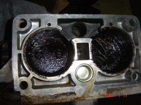 1993 Ford Bronco - Throttle body interior heavily coated in carbon deposits and debris.