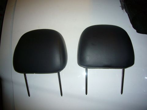 2000 Ford Crown Victoria - A pair of black leather headrests are shown, each with two metal support posts.