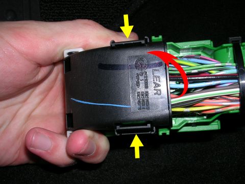 2007 Mazda 3 - Wiring harness connector with 'LEAR' branding is held by a hand, showing multiple wires.