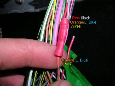 2007 Mazda 3 - A hand holds a wiring harness, with labels indicating specific wire colors for reference.
