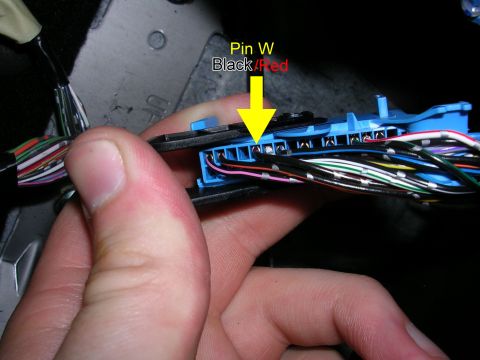 2007 Mazda 3 - Close-up of a wiring harness connector, with a yellow arrow indicating Pin W, labeled as Black/Red.