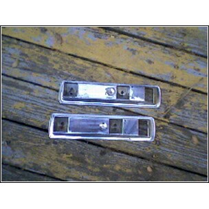 1973 Ford Ranchero - Pair of tail light bezels, likely for an older vehicle, shown on a wooden surface.