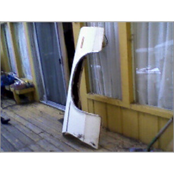 White fender with a red stripe on the side, resting on a wooden deck