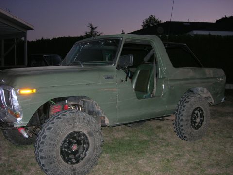 1978 Ford Bronco - This modified SUV features an off-road suspension and large tires, seen parked outdoors as daylight fades.