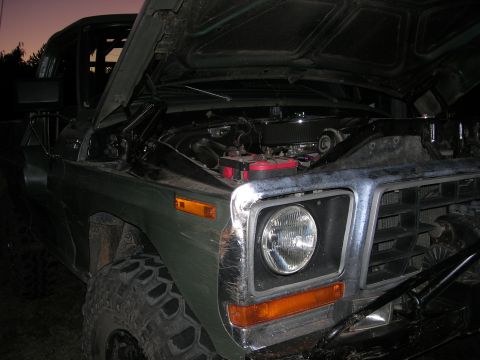 1978 Ford Bronco - Front view of a 1978 Ford Bronco, hood open, revealing the engine compartment.