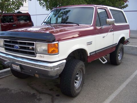 1991 Ford Bronco - Two-tone 1991 Ford Bronco parked outdoors, with a second SUV in the background.