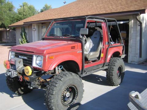 1987 Suzuki Samurai - Modified 1987 Suzuki Samurai features a full roll cage and aggressive off-road tires.