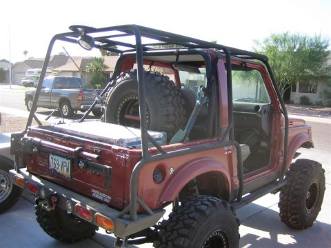 1987 Suzuki Samurai - This heavily modified 1987 Suzuki Samurai features an extensive external roll cage and large off-road tires.