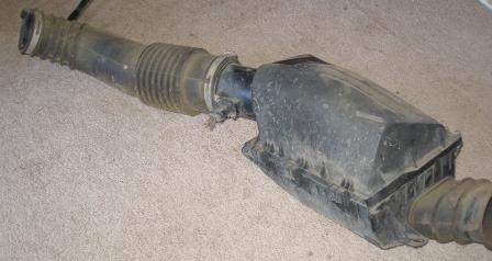 2000 Ford Crown Victoria - Air intake assembly from a Ford vehicle, showing the intake tube and air filter box.