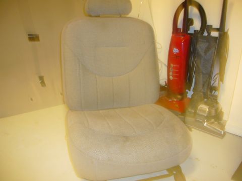 2000 Ford Crown Victoria - A tan car seat is shown, with two vacuum cleaners visible in the background.