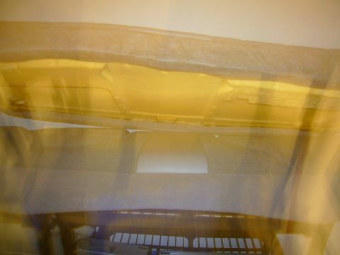 2000 Ford Crown Victoria - The interior headliner of a vehicle is partially covered with protective material.