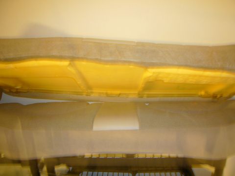 2000 Ford Crown Victoria - Close-up view of car seat foam padding, showing the yellow cushioning material beneath a protective covering.