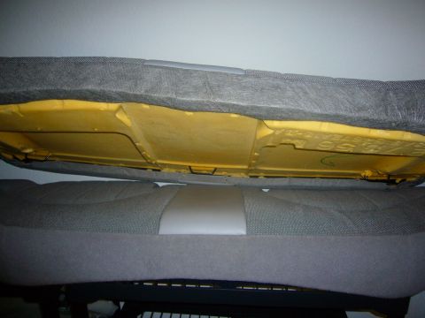 2000 Ford Crown Victoria - Underside of a car seat showing yellow foam padding and internal structure.
