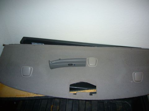 2000 Ford Crown Victoria - A close-up view of a car's interior trim panel, showing a handle and latches.