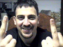 1973 Ford Ranchero - A man smiles while giving the middle finger with both hands.