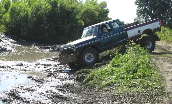 1979 Ford F-250 Supercab navigating a muddy trail
