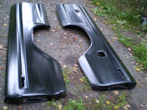 1979 Ford Bronco - Two black truck bedsides are shown laid out on the ground, likely for sale or restoration.